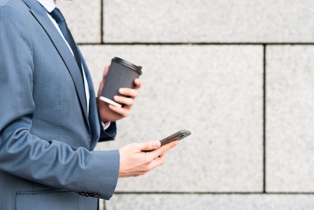 Free photo businessman holding coffee cup