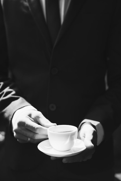 Businessman holding coffee cup