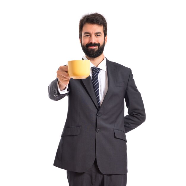 Businessman holding a cup of coffee over white background