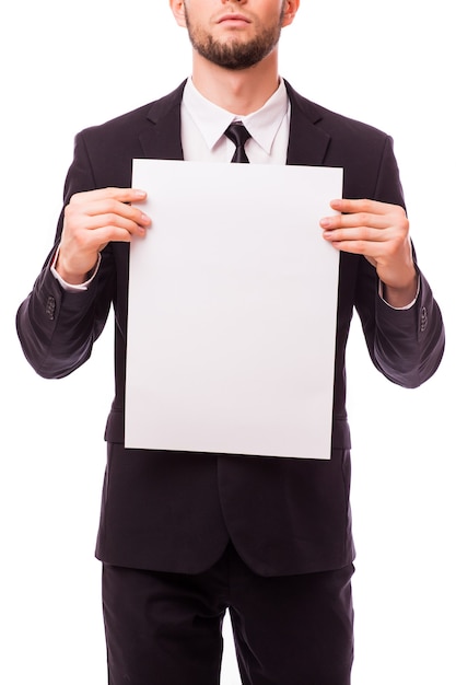 Businessman holding empty white placard showing copy space isolated on white