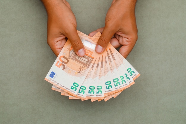 businessman holding euro bills.