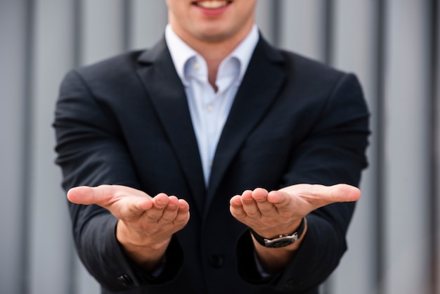 Businessman holding his hands out