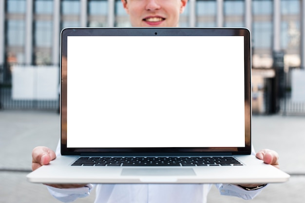 Businessman holding laptop mock-up