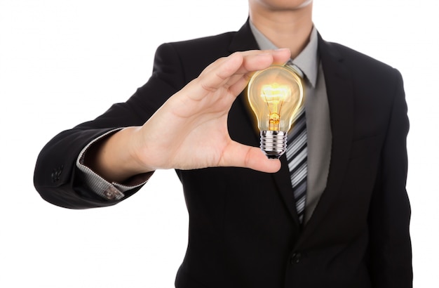 Businessman holding a lit light bulb in his hand