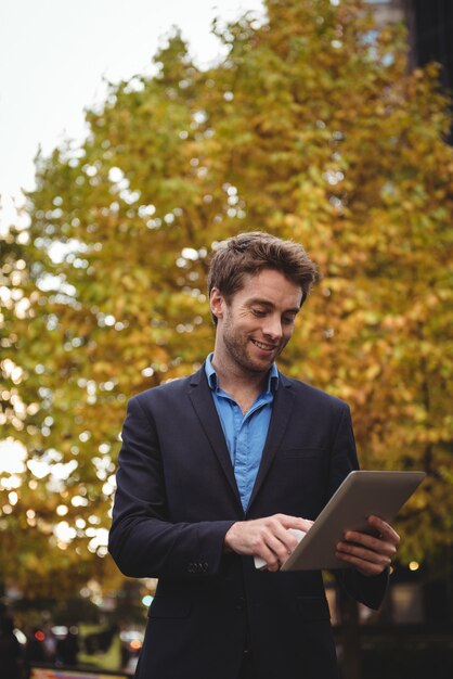 Businessman holding mobile phone and using digital tablet