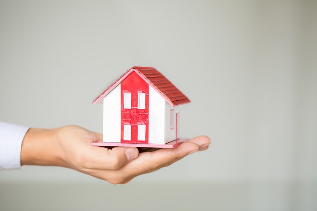 Businessman Holding Model House 