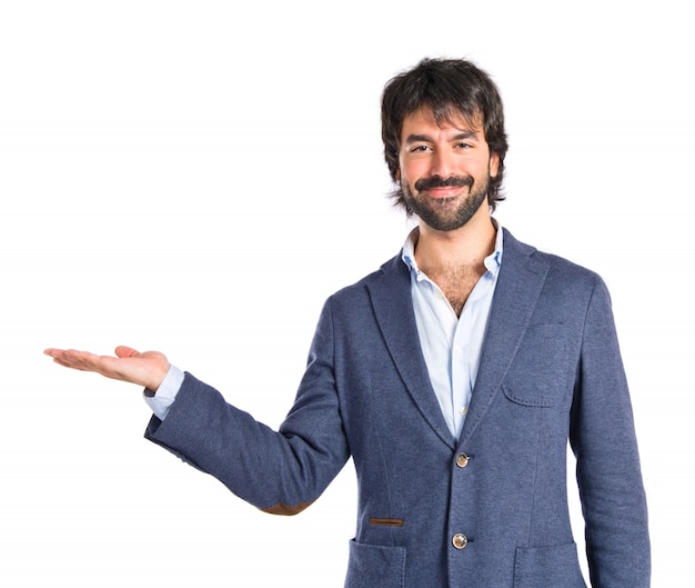 Businessman holding something over white background