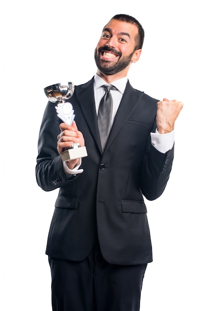 Free photo businessman holding a trophy