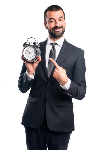 Businessman holding vintage clock