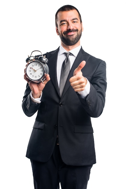 Businessman holding vintage clock