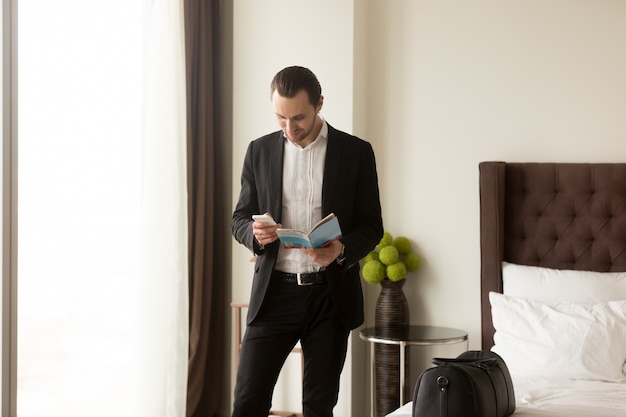 Businessman holds guide brochure