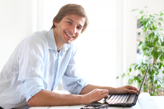 Free photo businessman at home using laptop