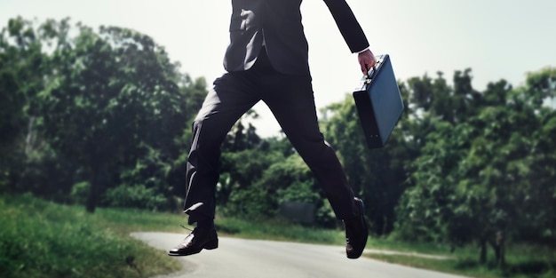 Free photo businessman jump up in the park