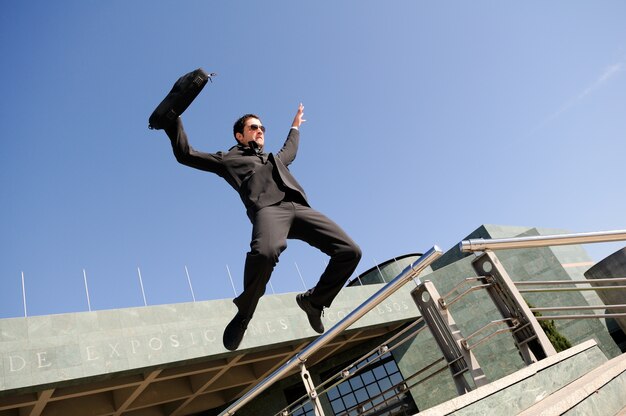 Businessman jumping with a briefcase