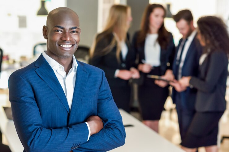 Free Photo businessman leader in modern office with businesspeople working