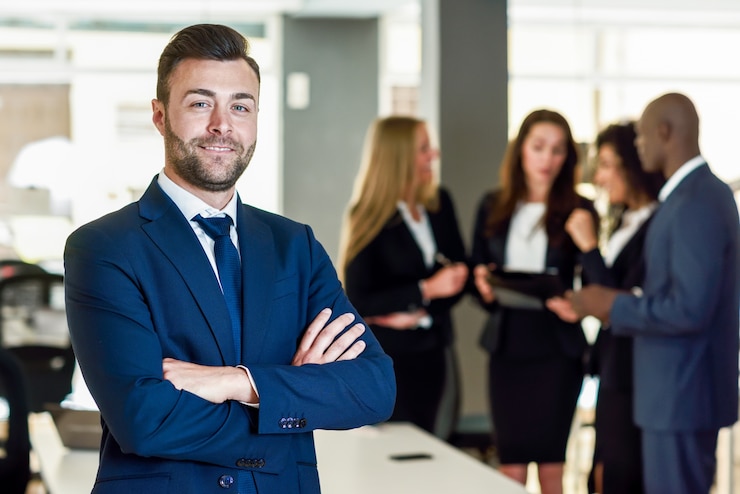 Free Photo businessman leader in modern office with businesspeople working