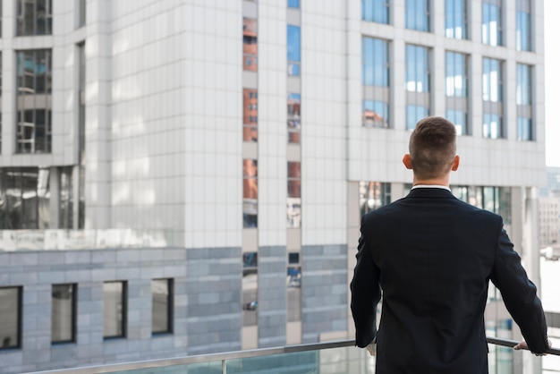 Businessman looking at building