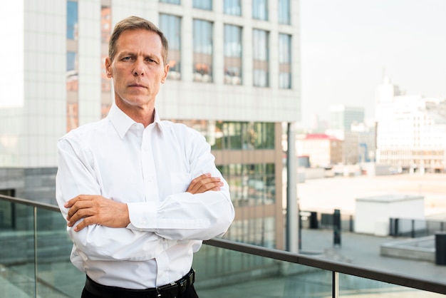 Businessman looking at camera with arms crossed