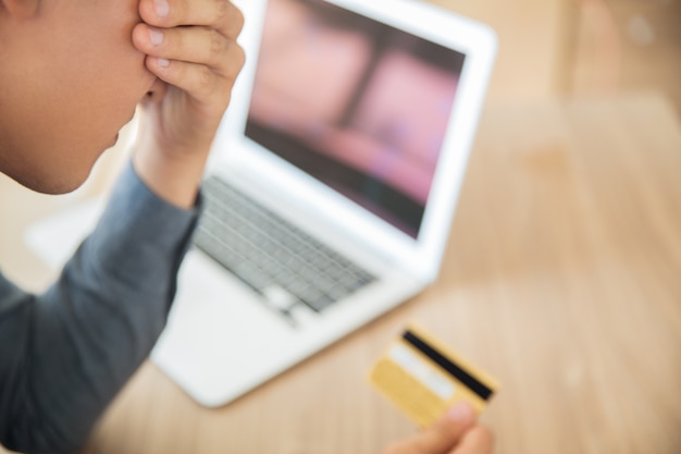 Businessman looking at credit card in stress