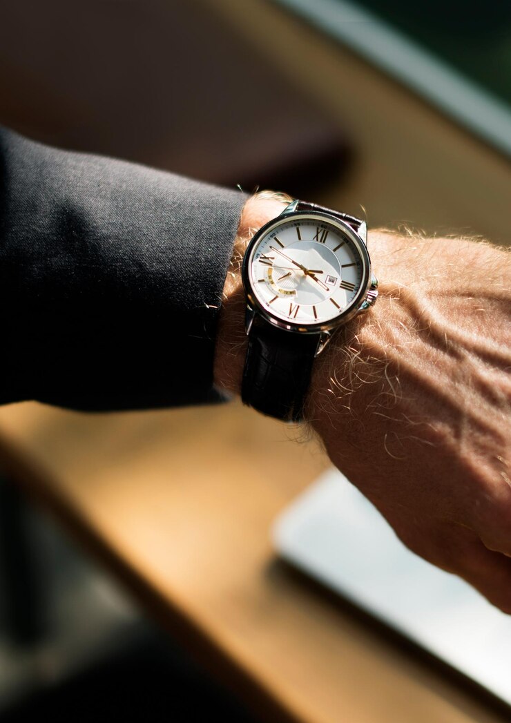 Free Photo businessman looking at his watch closeup
