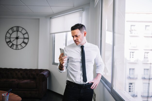 Businessman looking at smartphone