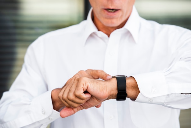 Businessman looking at wrist watch