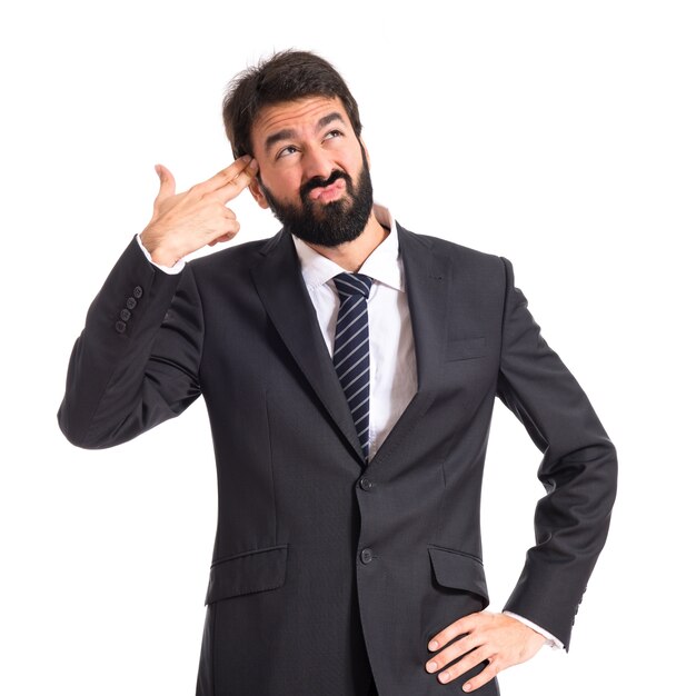 Businessman making gun gesture over white background