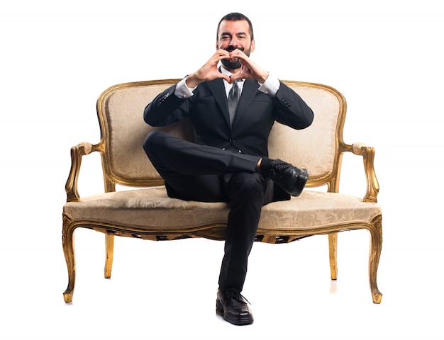 Free photo businessman making a heart with his hands