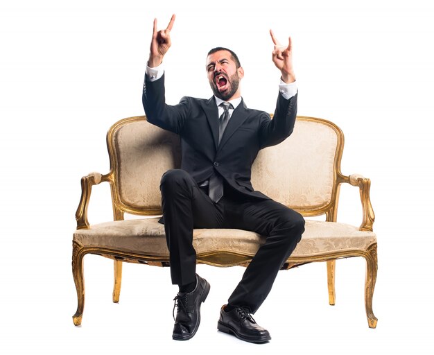 Businessman making horn gesture