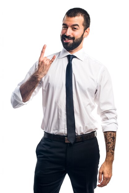 Businessman making horn gesture