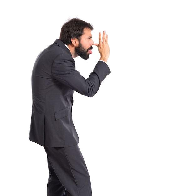 Businessman making a joke over white background