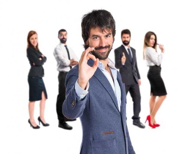 Businessman making Ok sign over white background