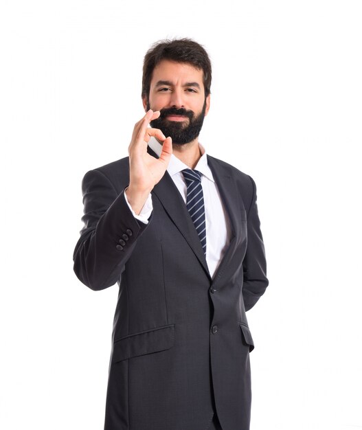 Businessman making Ok sign over white background