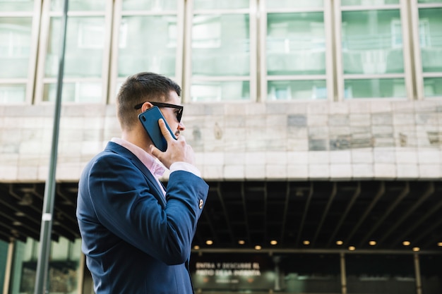 Businessman making phone call in urban environment