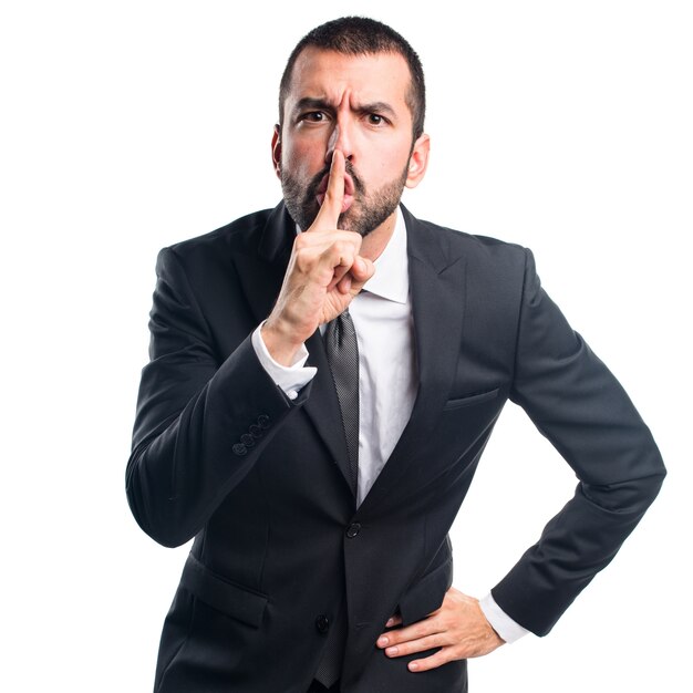 Businessman making silence gesture