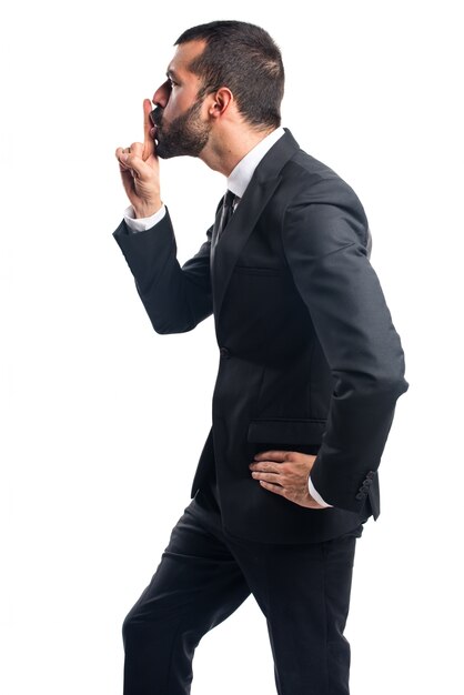 Businessman making silence gesture