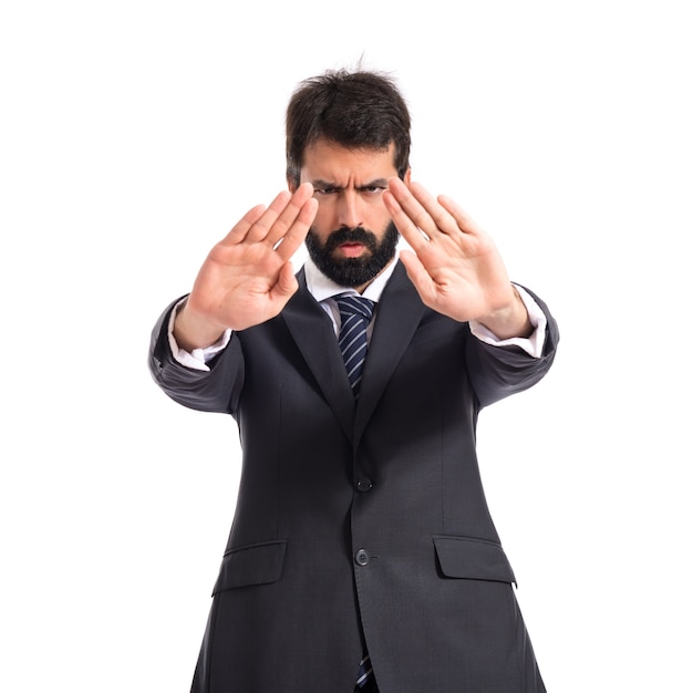 Free photo businessman making stop sign over white background