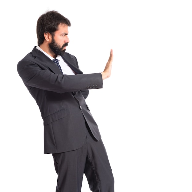 Free photo businessman making stop sign over white background