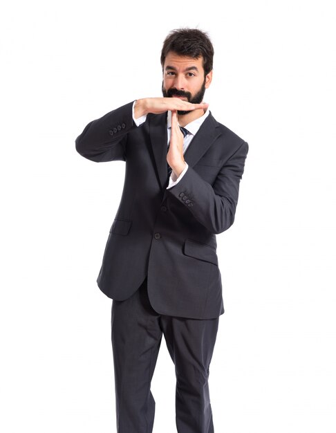 Businessman making time out gesture over white background