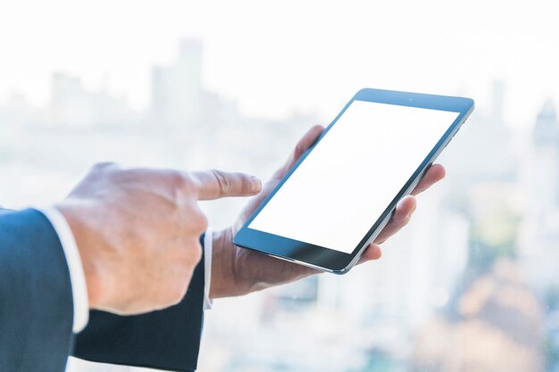 Businessman pointing finger on digital tablet with blank screen