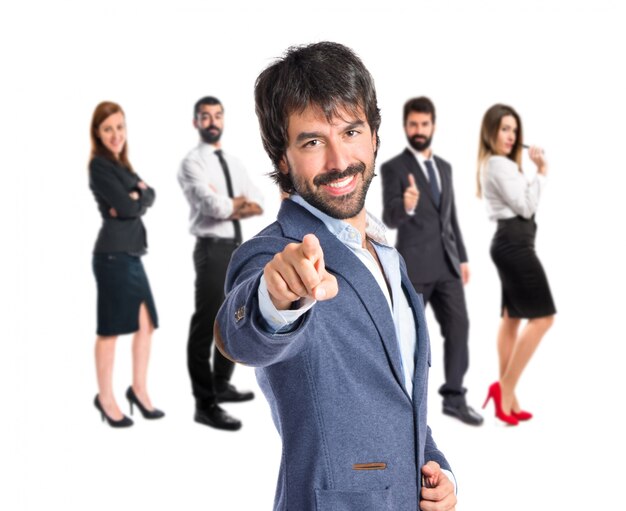 Businessman pointing to the front over white background