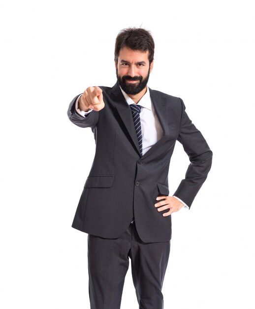 Businessman pointing to the front over white background