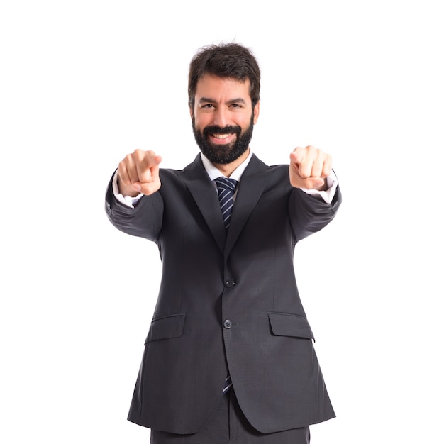 Businessman pointing to the front over white background