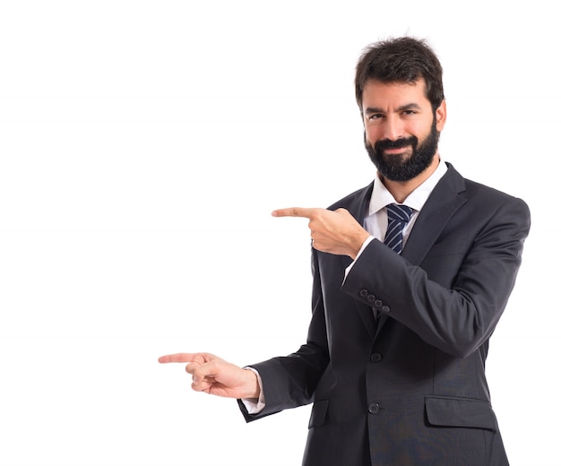 Businessman pointing to the lateral over white background