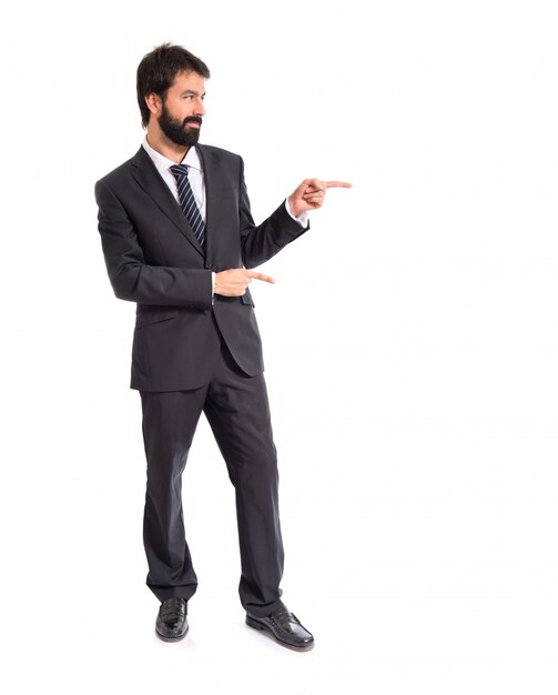 Businessman pointing to the lateral over white background