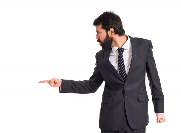 Businessman pointing and shouting over isolated white background