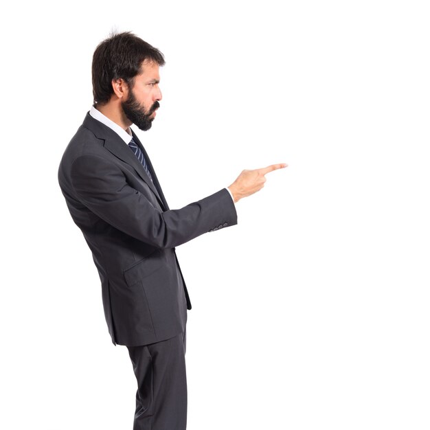 Businessman pointing and shouting over isolated white background