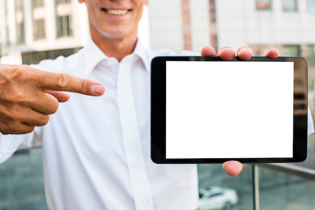 Businessman pointing at tablet mock-up