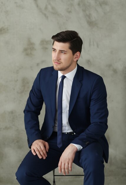 Businessman posing on chair