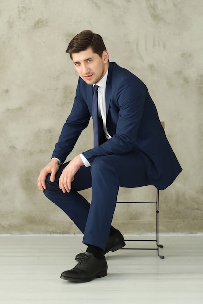 Businessman posing on chair